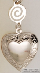 Silver-toned heart shaped locket with delicate engraving & round connector with a swirl design