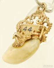 Mixed 14k, 10k and enamel BPOE elk's tooth pocket watch chain fob, approx. 5.1dwt.