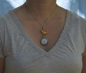 Pin, as pendant on necklace