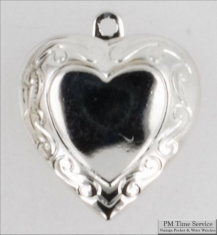 Silver-toned heart shaped locket with delicate engraving