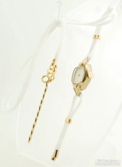 Vintage repurposed Caravelle by Bulova ladies' wrist watch with a white watch band cord necklace