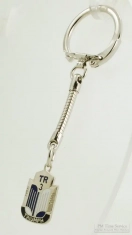 Base metal and enamel Triumph TR3 shield fob with a matching latch-style key chain
